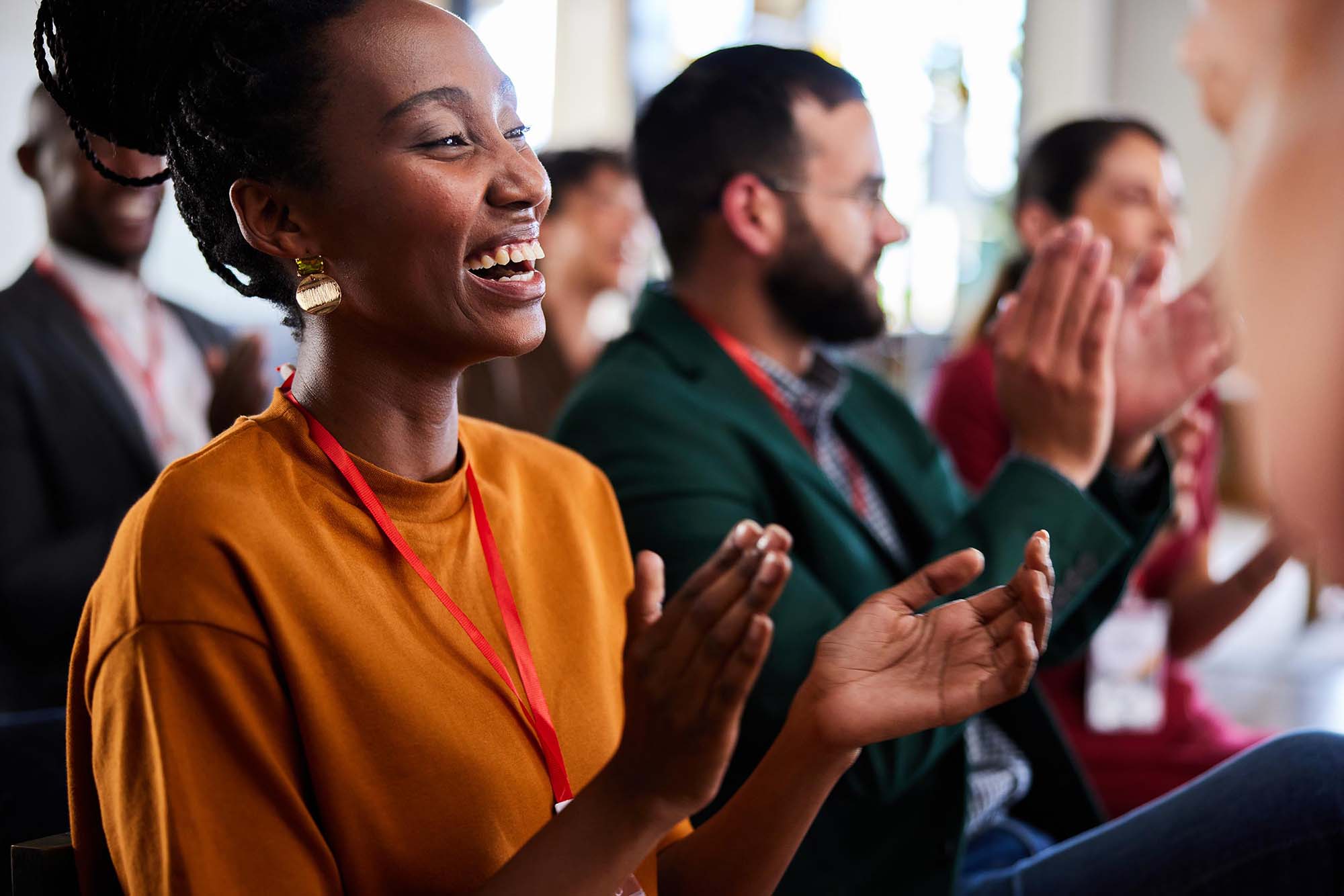 Coworkers clapping in office