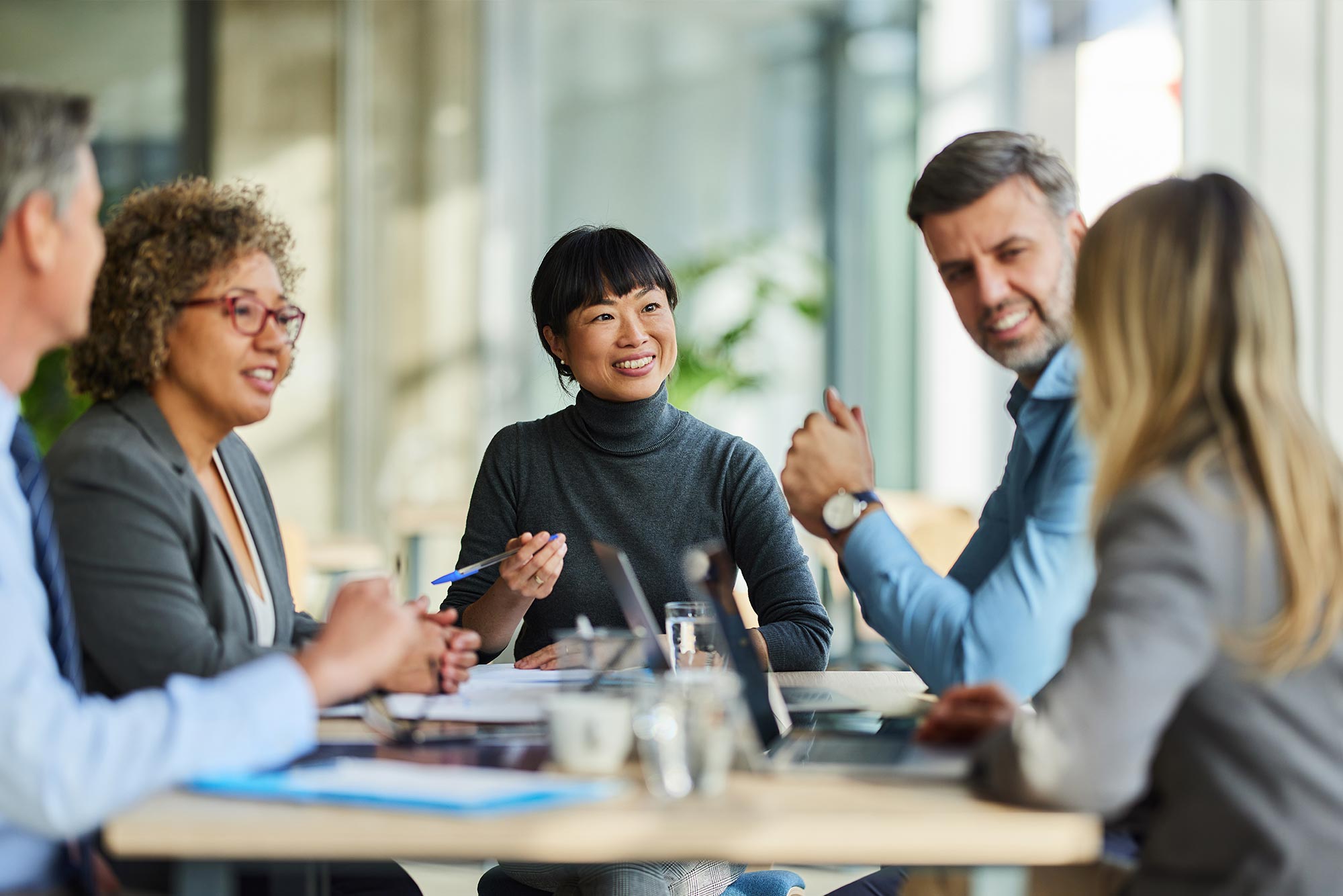 Coworkers talking during meeting in office